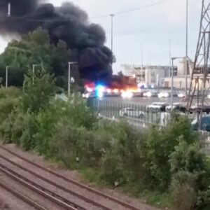 Firefighters are tackling a large fire involving multiple hybrid vehicles off West Bay Road in Southampton this morning.
Crews were called to the scene at around 5.50am today, Wednesday 3 June 2026, with a major firefighting response now in attendance.
There are currently 10 fire engines, two water carriers, an aerial ladder platform and several support vehicles at the scene.
Firefighters are using jets, the aerial ladder platform and ground monitors to bring the blaze under control.
Residents living nearby are being advised to keep doors and windows closed due to smoke in the area.
A ground monitor is a heavy-duty, high-flow firefighting device placed on the ground to deliver large volumes of water or foam from a safe distance.
People are urged to avoid the area while emergency services deal with the incident.
More updates to follow.
Suggested hashtags:
#Southampton #WestBayRoad #BreakingNews #Hampshire #FireService #EmergencyServices #VehicleFire #HampshireNews #SouthamptonNews