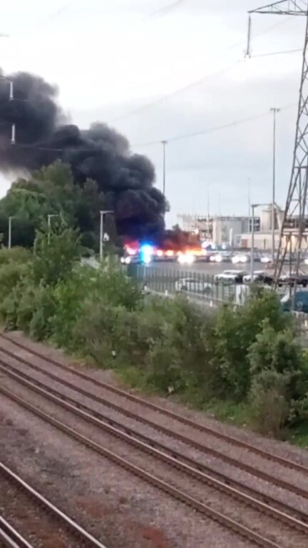 Firefighters are tackling a large fire involving multiple hybrid vehicles off West Bay Road in Southampton this morning. Crews were called to the scene at around 5.50am today, Wednesday 3 June 2026, with a major firefighting response now in attendance. There are currently 10 fire engines, two water carriers, an aerial ladder platform and several support vehicles at the scene. Firefighters are using jets, the aerial ladder platform and ground monitors to bring the blaze under control. Residents living nearby are being advised to keep doors and windows closed due to smoke in the area. A ground monitor is a heavy-duty, high-flow firefighting device placed on the ground to deliver large volumes of water or foam from a safe distance. People are urged to avoid the area while emergency services deal with the incident. More updates to follow. Suggested hashtags: #Southampton #WestBayRoad #BreakingNews #Hampshire #FireService #EmergencyServices #VehicleFire #HampshireNews #SouthamptonNews